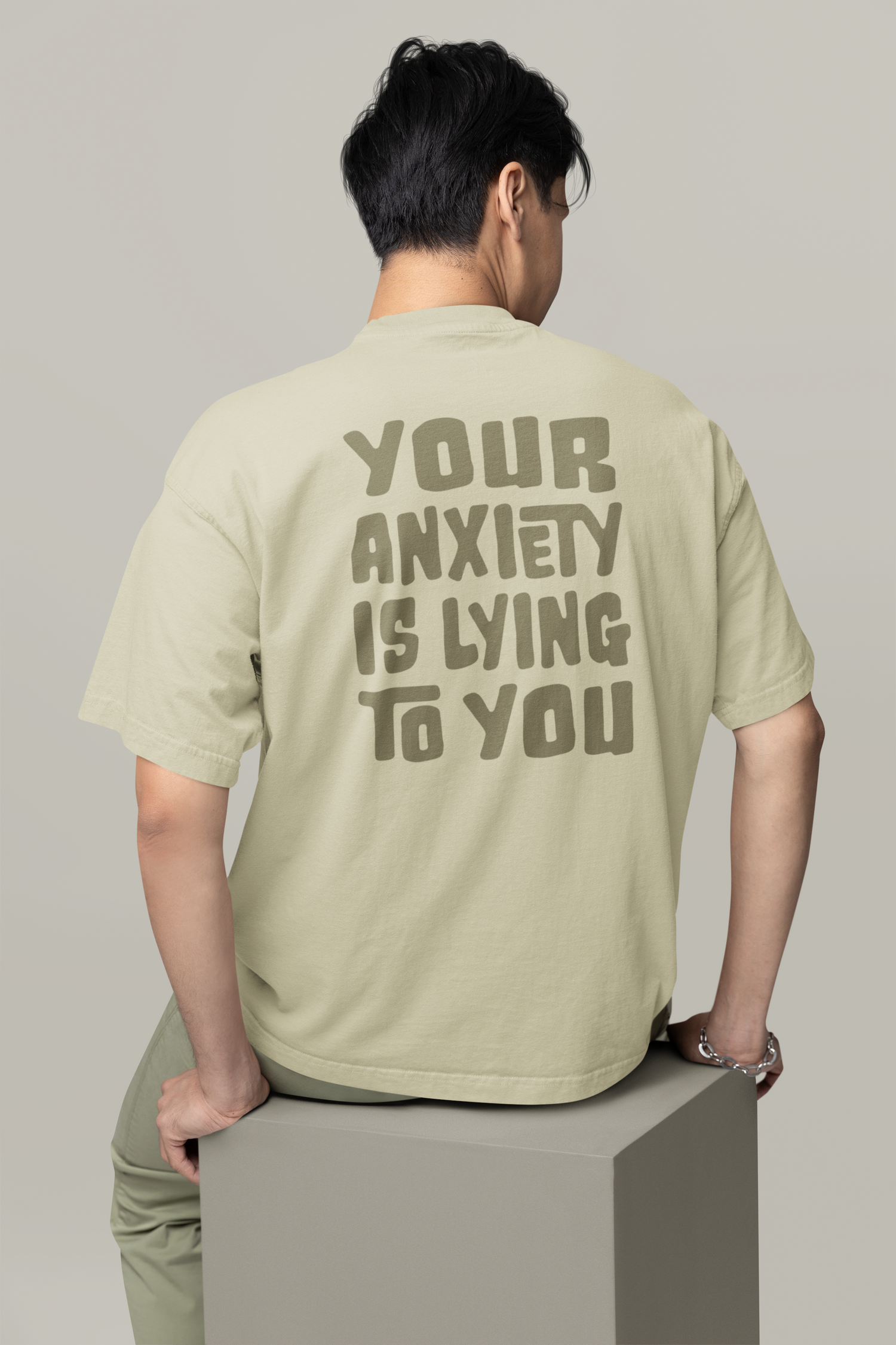 Oversized faded Eucalyptus T-shirt featuring a bold back graphic with the text: "Your anxiety is lying to you.