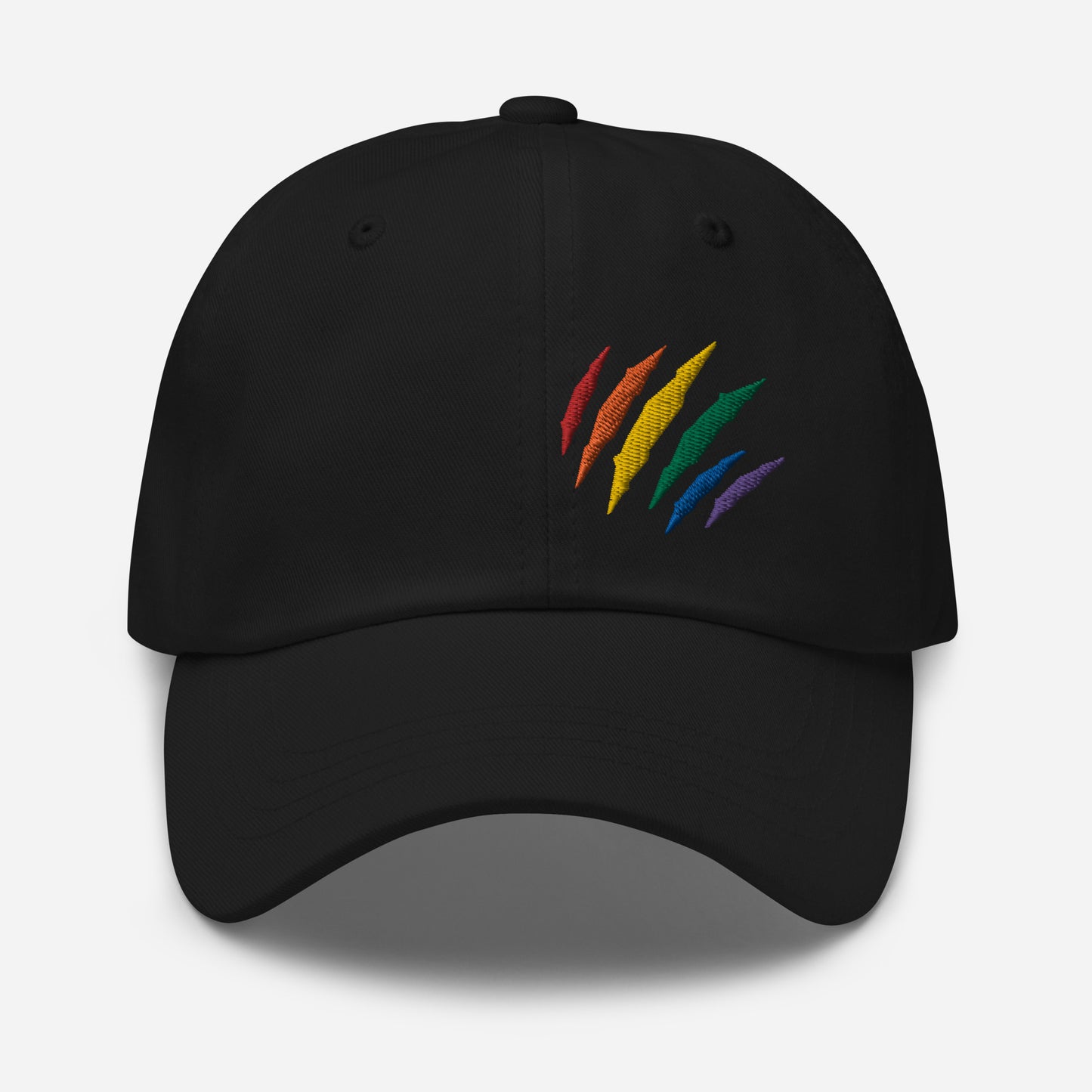 Black baseball hat featuring rainbow pride scratch mark embroidery with a low profile, adjustable strap.