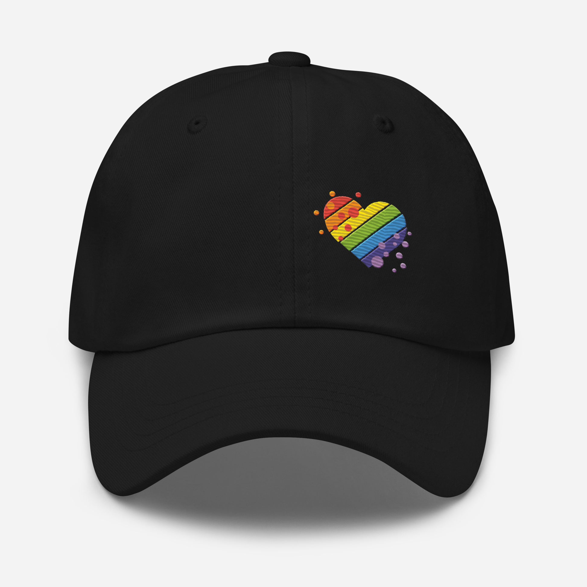 Black baseball hat featuring rainbow heart design embroidery with a low profile, adjustable strap.