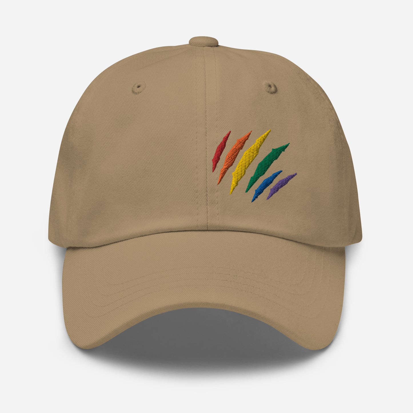 Khaki baseball hat featuring rainbow pride scratch mark embroidery with a low profile, adjustable strap.