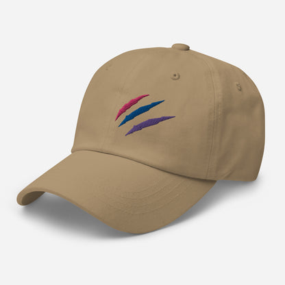 Baseball hat featuring bisexual pride scratch mark embroidery in khaki with a low profile, adjustable strap.