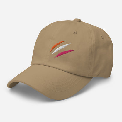 Khaki baseball hat featuring lesbian pride scratch mark embroidery with a low profile, adjustable strap.