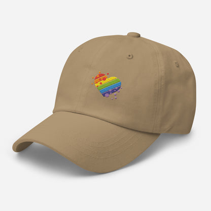 Khaki baseball hat featuring rainbow heart design embroidery with a low profile, adjustable strap.