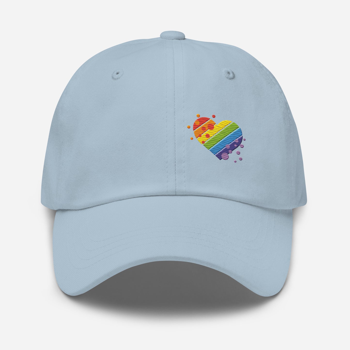 Light blue baseball hat featuring rainbow heart design embroidery with a low profile, adjustable strap.