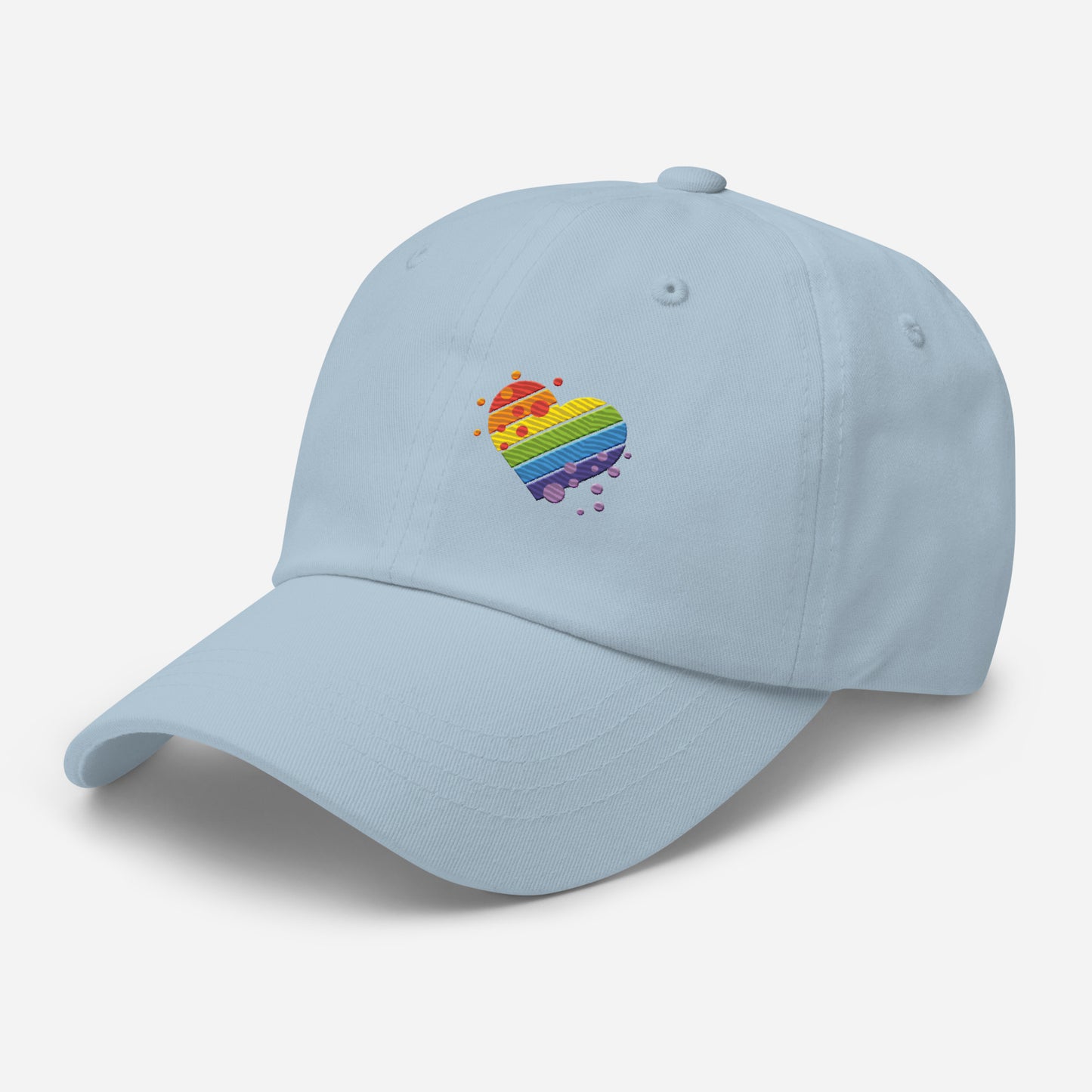Light blue baseball hat featuring rainbow heart design embroidery with a low profile, adjustable strap.