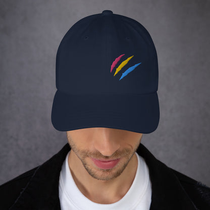 A male model wearing our navy baseball hat featuring pansexual pride scratch mark embroidery with a low profile, adjustable strap.