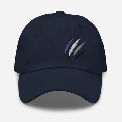 Baseball hat featuring asexual pride scratch mark embroidery in navy with a low profile, adjustable strap.