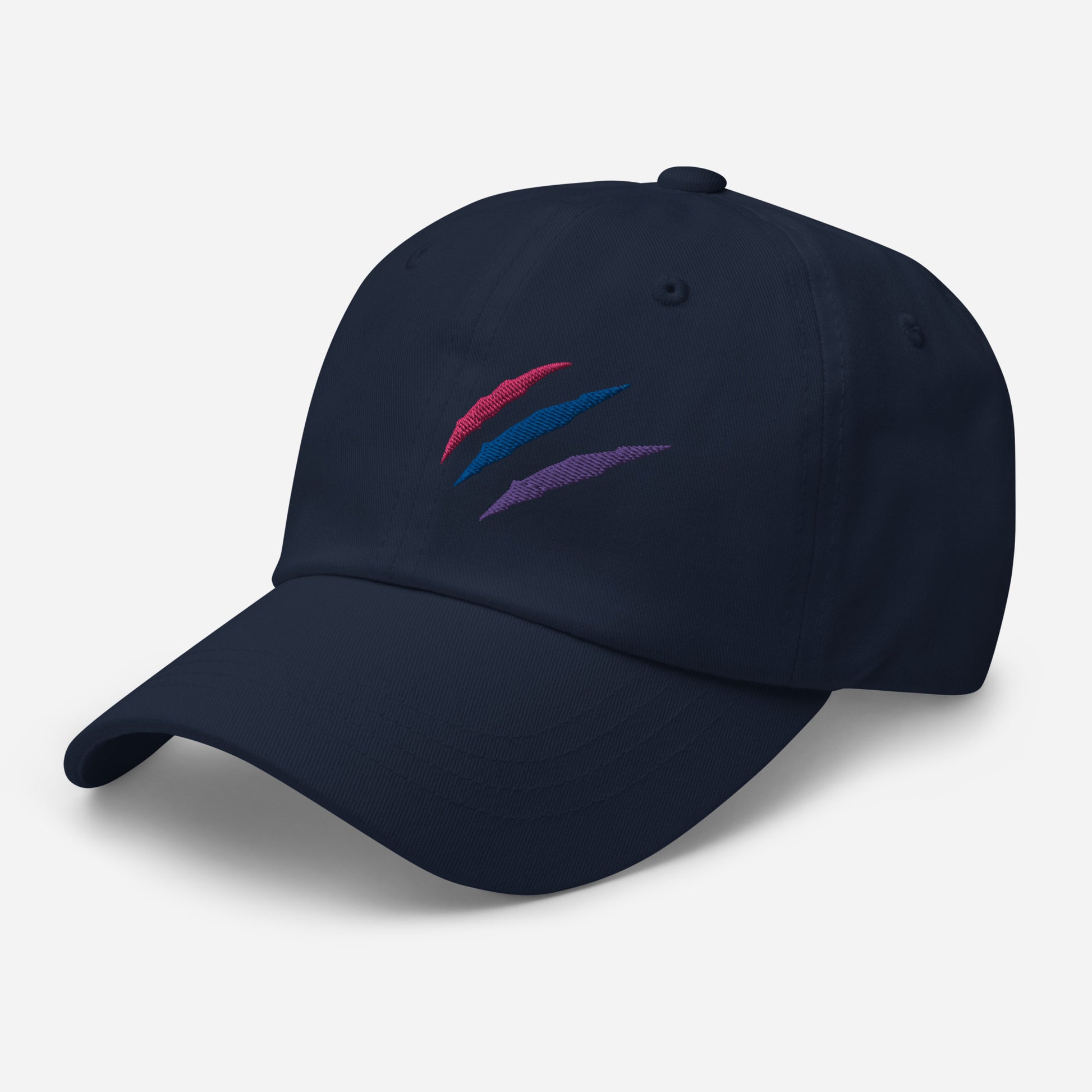 Baseball hat featuring bisexual pride scratch mark embroidery in navy with a low profile, adjustable strap.