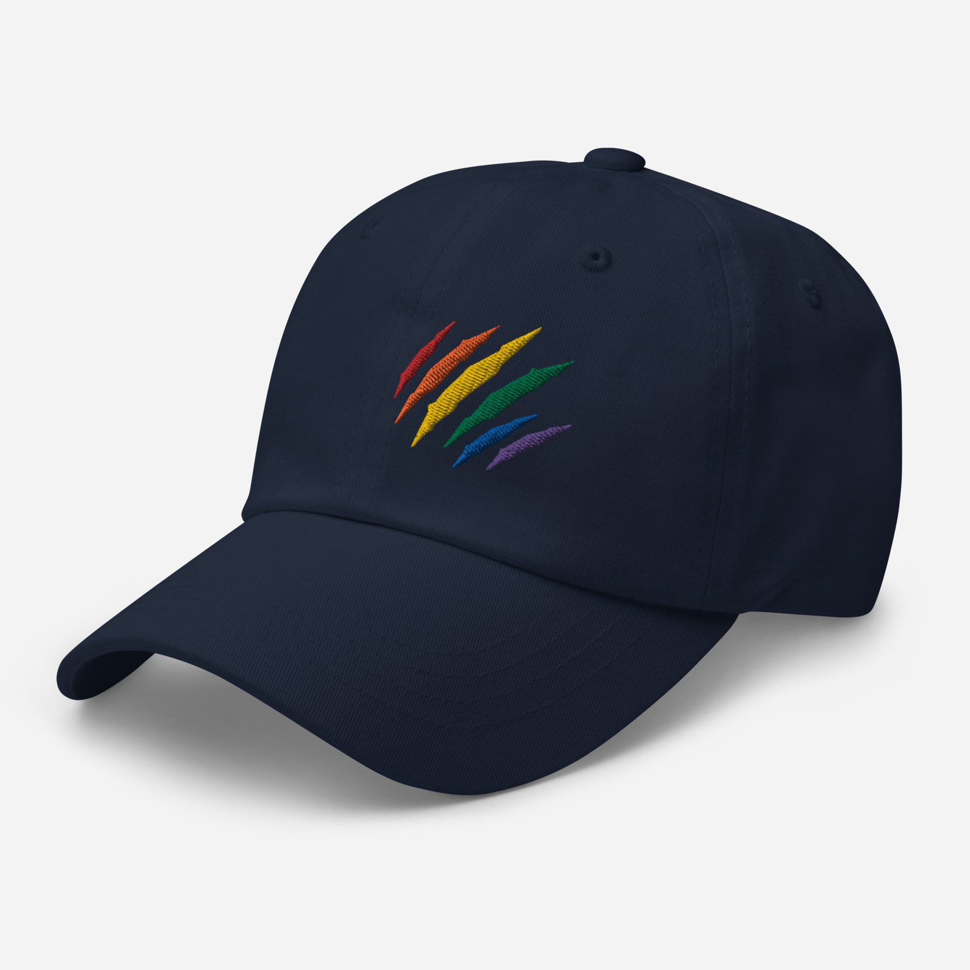 Navy baseball hat featuring rainbow pride scratch mark embroidery with a low profile, adjustable strap.