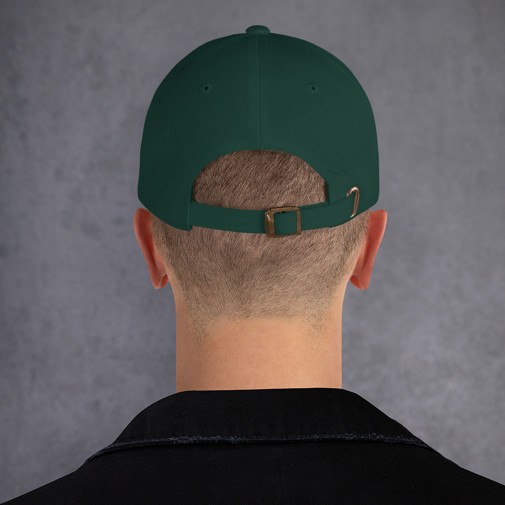 A male model wearing our spruce baseball hat featuring pant daddy embroidery with a low profile, adjustable strap.