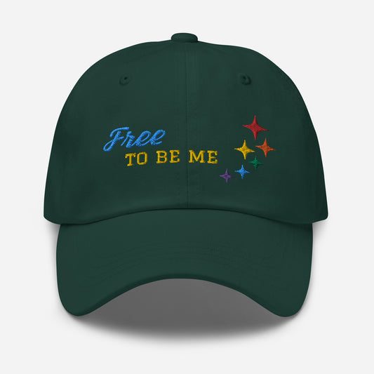 Spruce baseball hat featuring rainbow stars and free-to-be-me embroidered with a low profile, adjustable strap.
