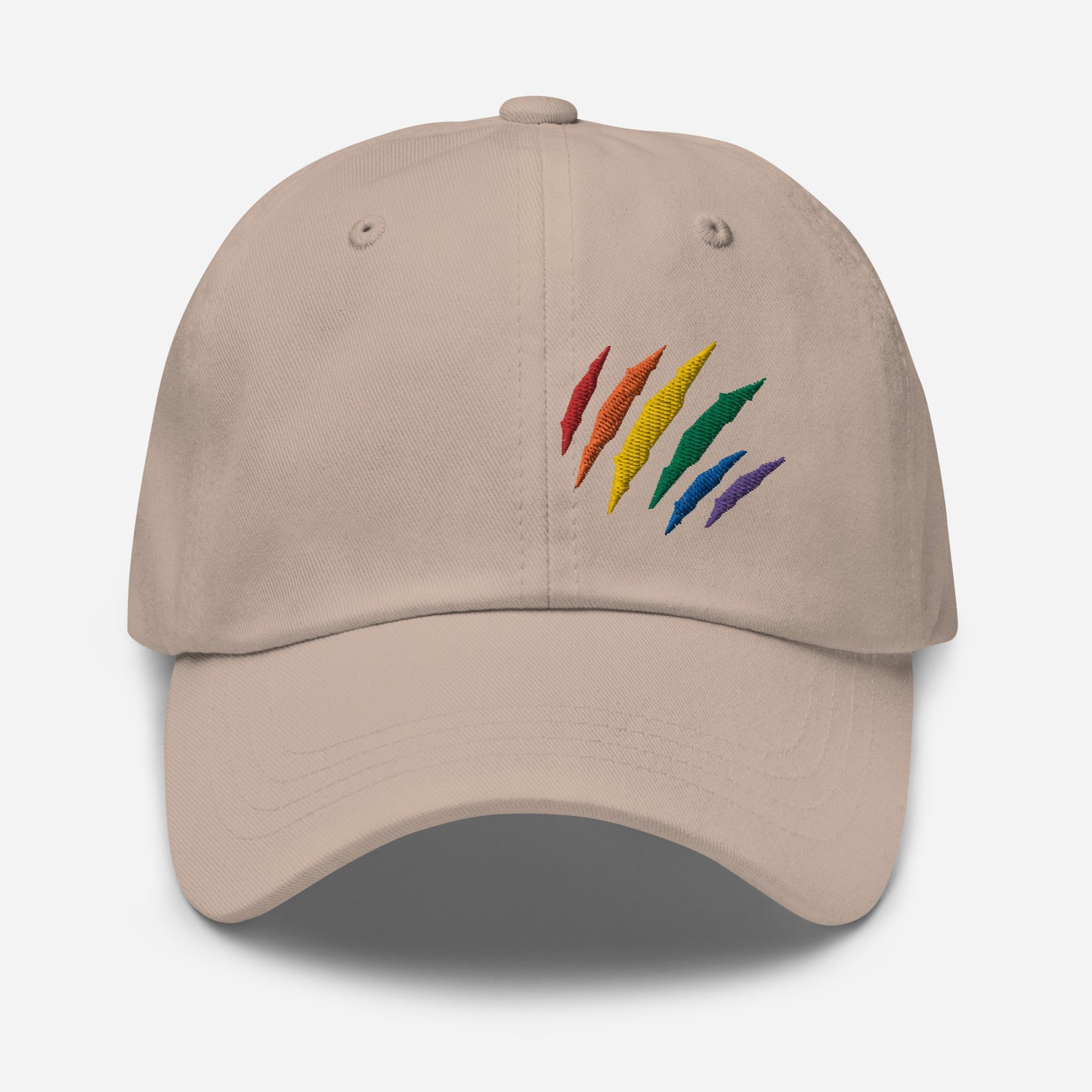 Stone baseball hat featuring rainbow pride scratch mark embroidery with a low profile, adjustable strap.