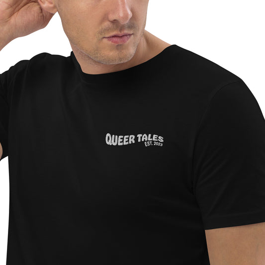 Male model wearing a fitted black organic cotton t-shirt with embroidered queer tales on the left chest. Available in sizes S to 2XL.