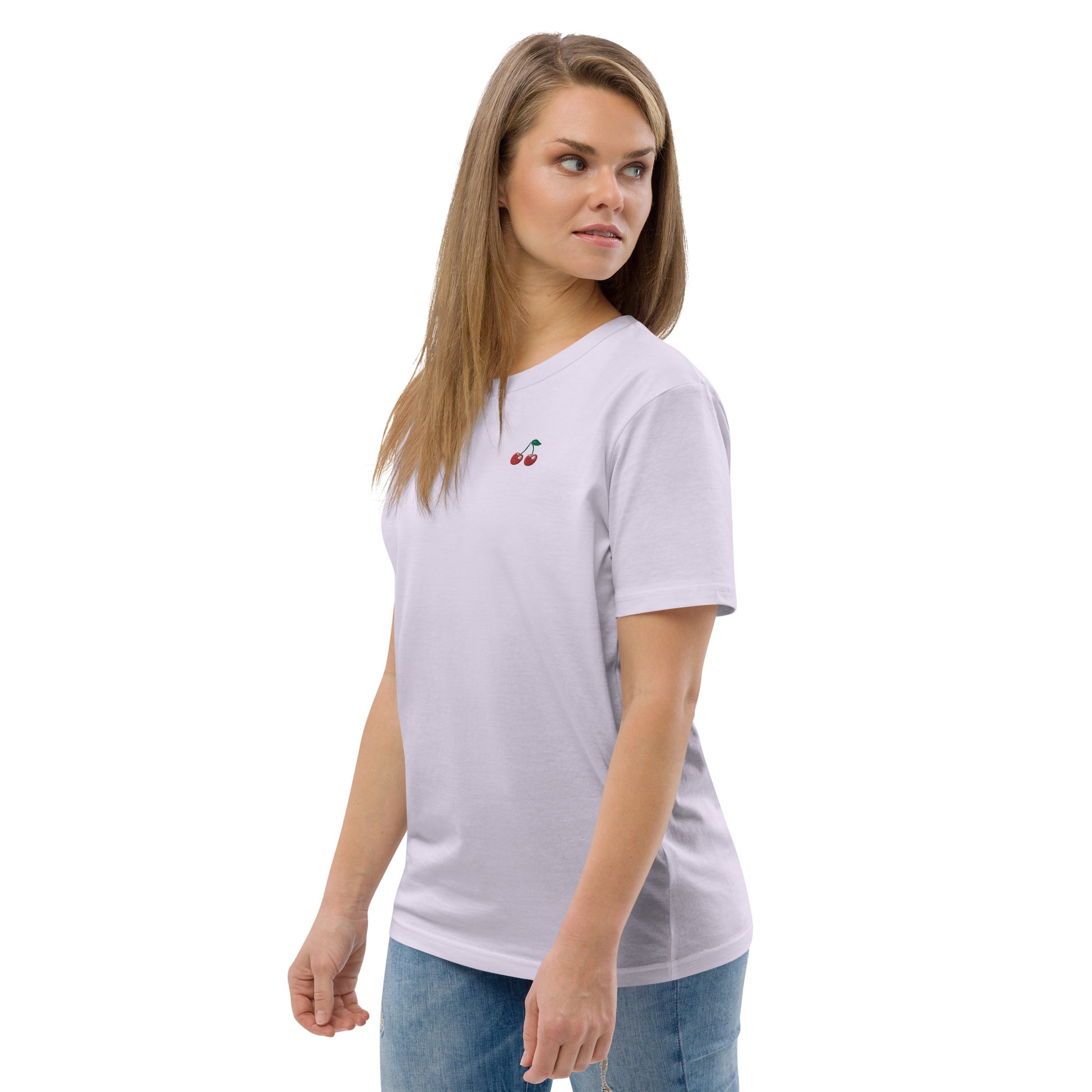 Female model wearing a relaxed lavender organic cotton t-shirt with small embroidered red cherries on the left chest. Available in sizes S to 3XL.