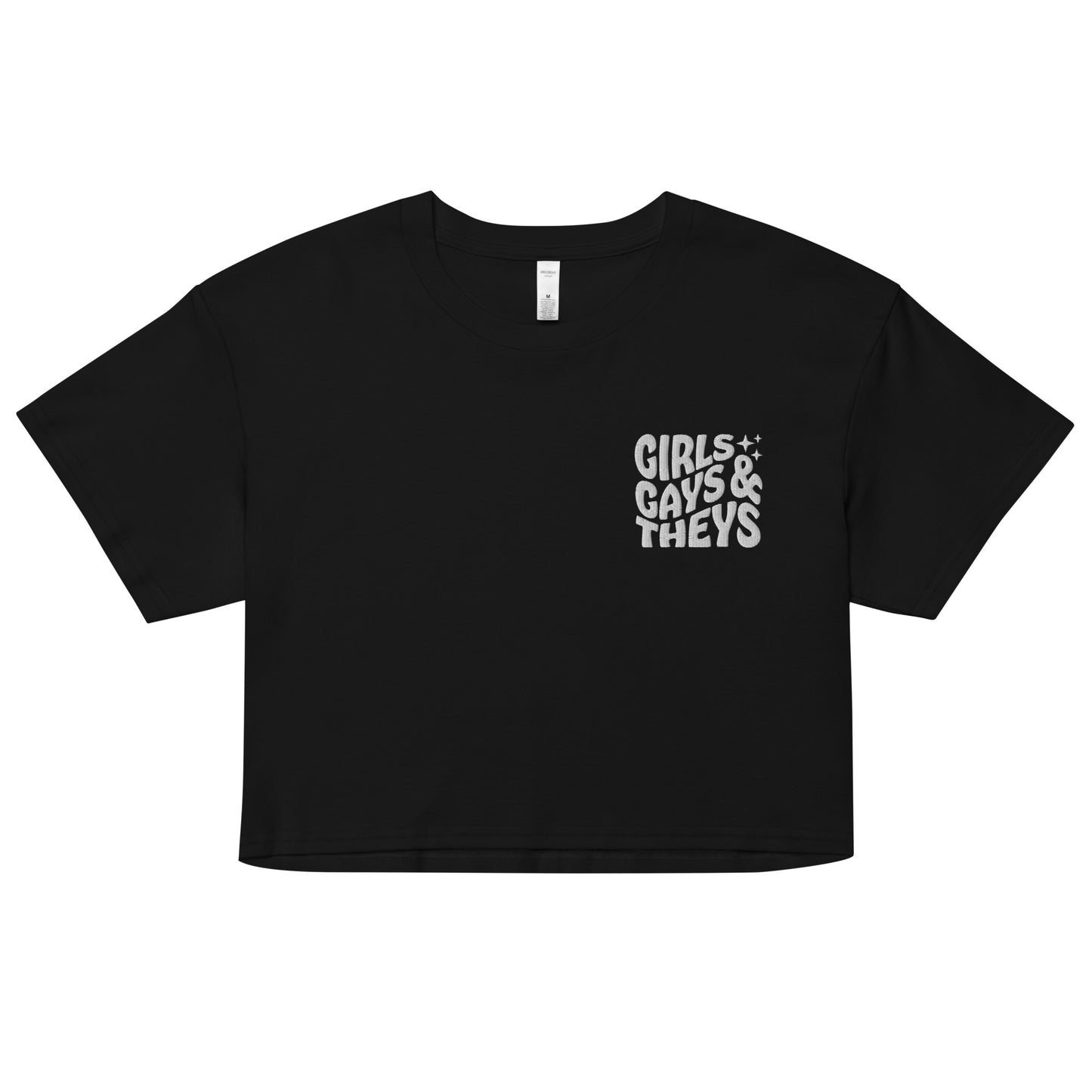 A relaxed, modest black crop top features a subtle white embroidery featuring the quote: girls gays & they's. Adding a touch of LGBTQ+ to your look—a playful celebration of queer culture! Made from 100% combed cotton. Available in Extra Small, Small, Medium, Large, Extra Large.