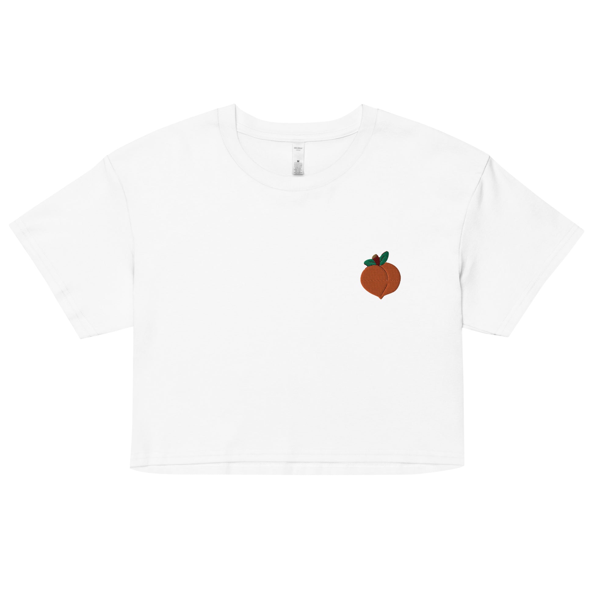 A relaxed, modest white crop top features a subtle peach emoji embroidery. Adding a touch of mischief to your look—a playful celebration of lgbtq culture! Made from 100% combed cotton. Available in Extra Small, Small, Medium, Large, Extra Large.