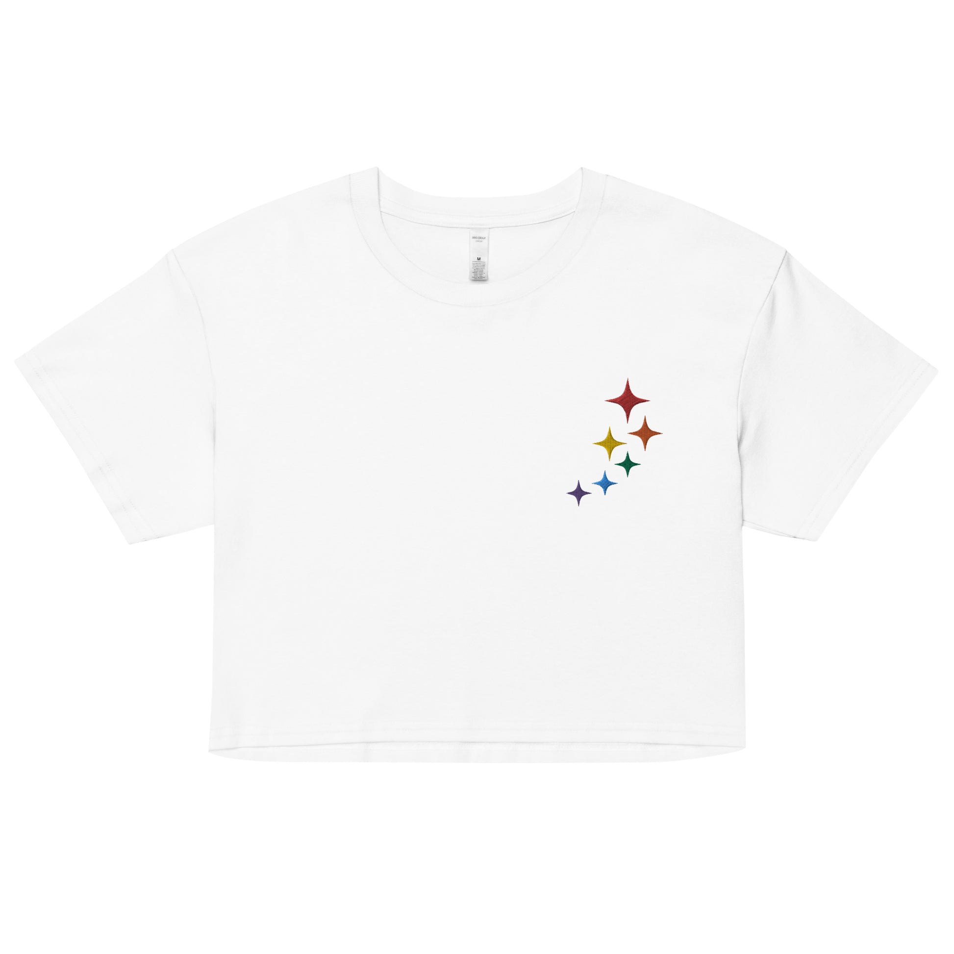 A relaxed, modest white crop top features a subtle rainbow stars embroidery. Adding a touch of rainbow to your look—a playful celebration of lgbtq culture! Made from 100% combed cotton. Available in Extra Small, Small, Medium, Large, Extra Large.