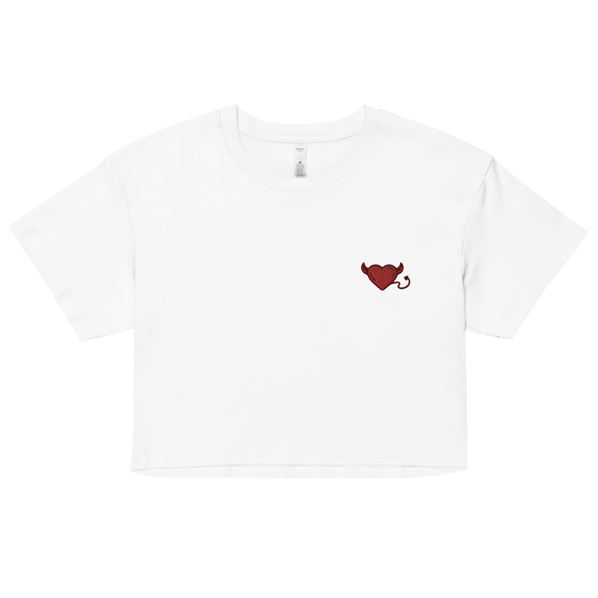 A relaxed, modest white crop top features a subtle red embroidery featuring a devil's heart. Adding a touch of mischief to your look—a playful celebration of lgbtq culture! Made from 100% combed cotton. Available in Extra Small, Small, Medium, Large, Extra Large.